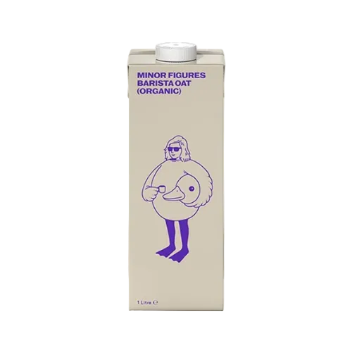 A 1 Liter carton of Minor Figures Barista Oat (Organic) oat milk. The carton is a warm cream-beige color with purple text and a purple line-art illustration of a person with a duck head.