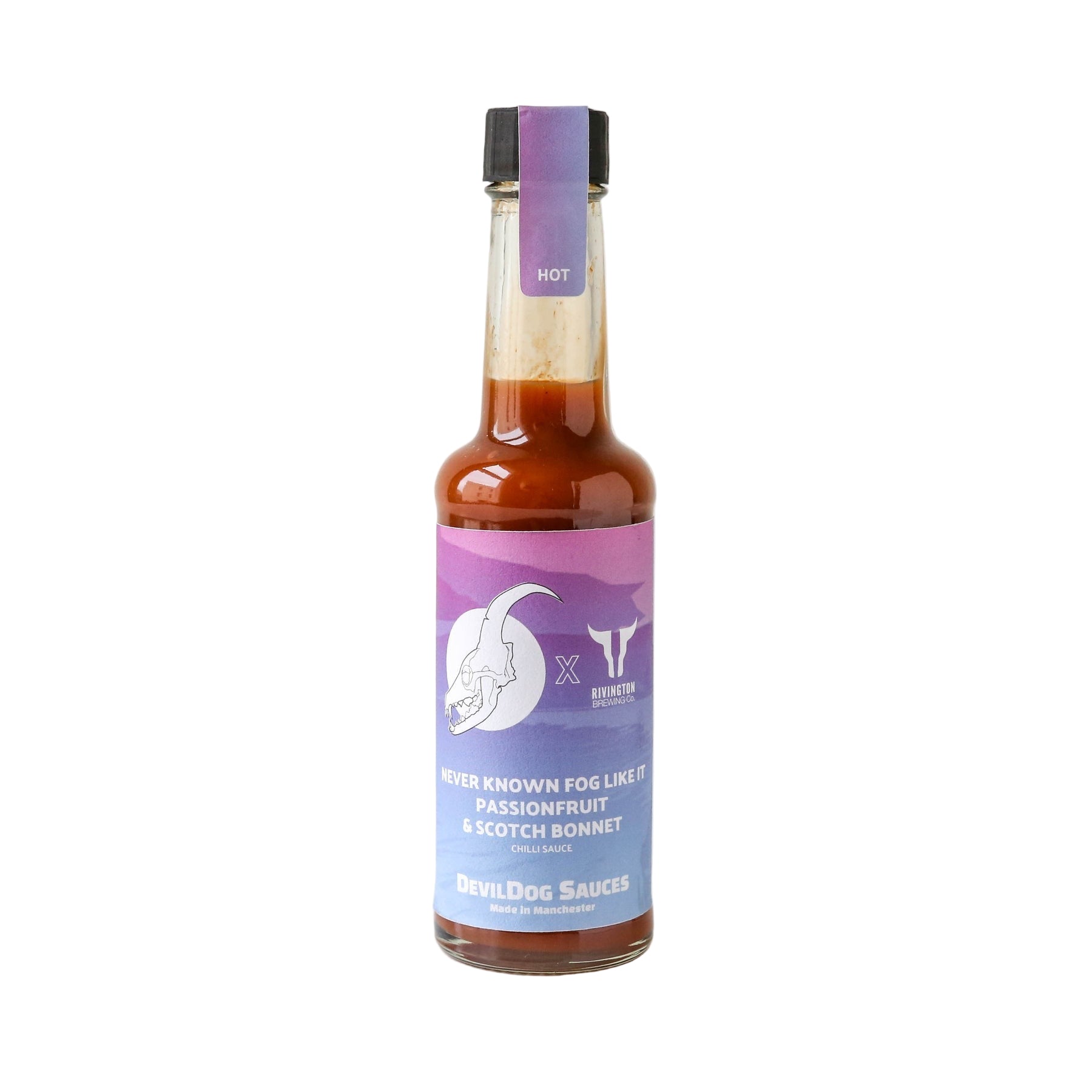 Close-up of Devil Dogs Passionfruit & Scotch Bonnet Hot Sauce on a white backgrounf