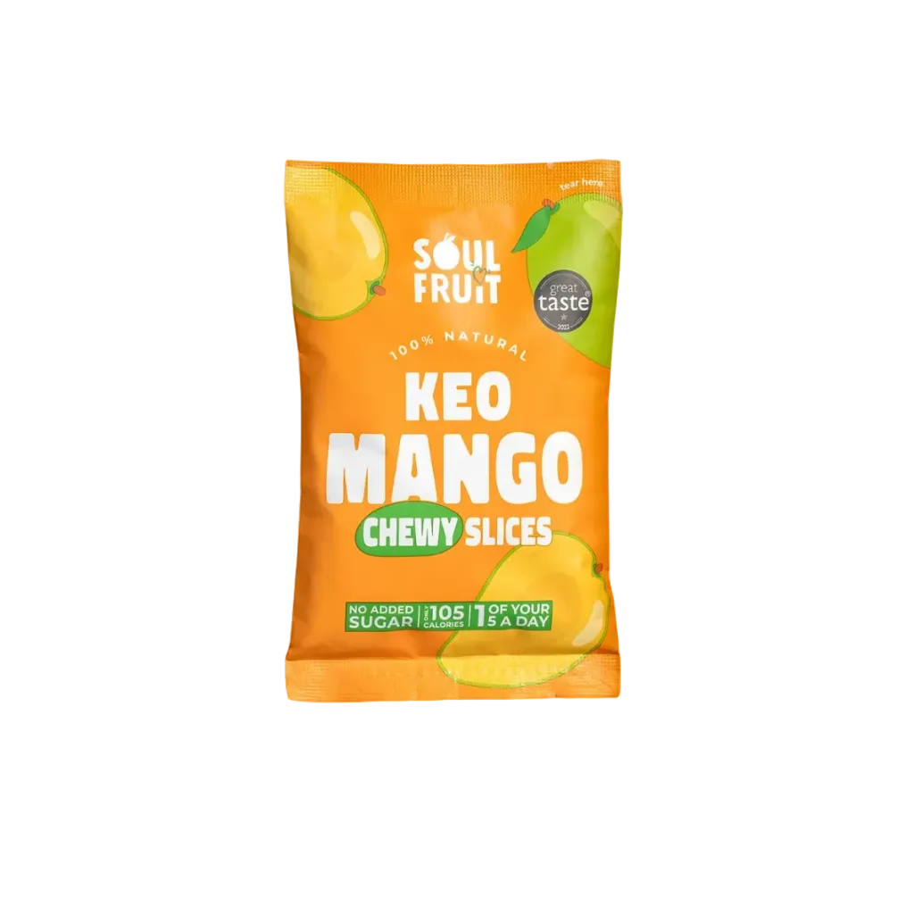 A single packet of Soul Fruit KEO Mango Chewy Slices on a solid orange background. The packaging is bright orange with illustrations of mango slices, white text, and a green badge indicating 'great taste'.