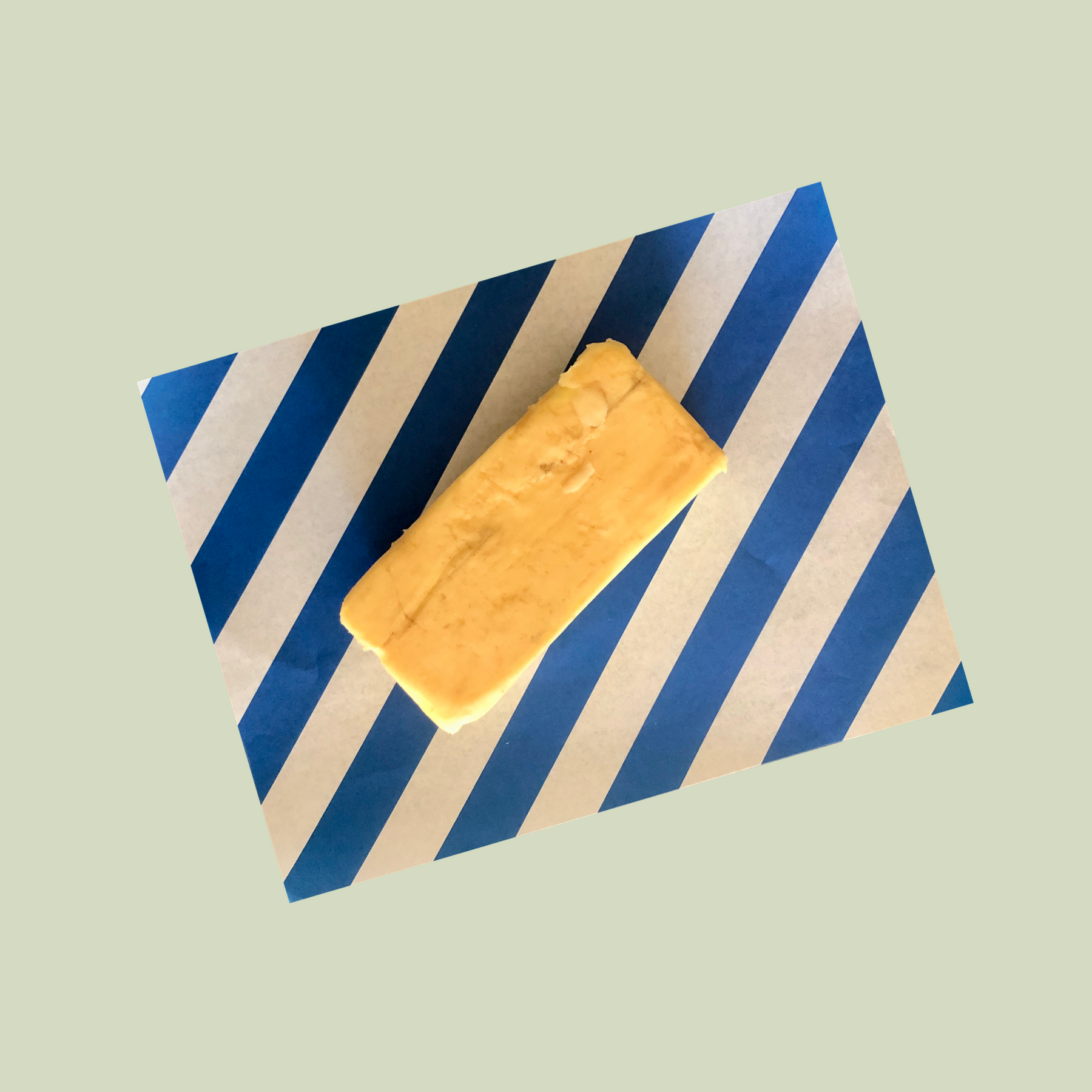 Curing Rebels smoked butter open and placed on a piece of striped parchment 