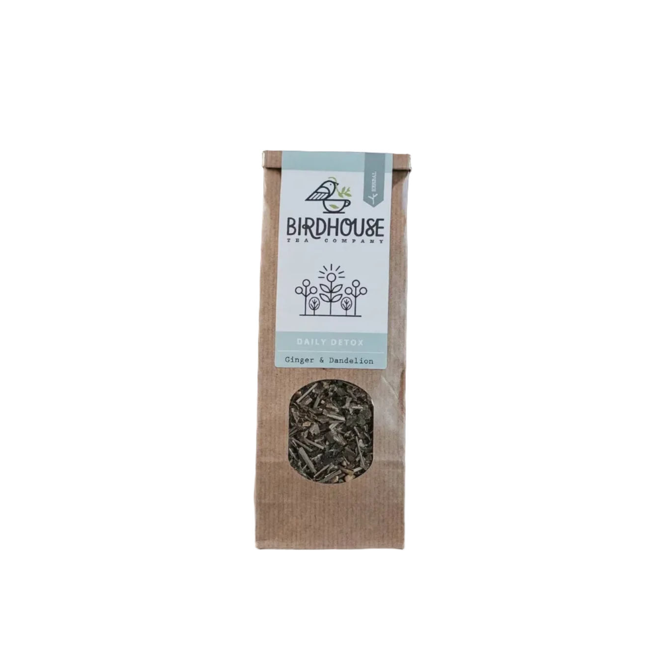 Tea package with visible brand name on a surface with a plant and brick wall in the background