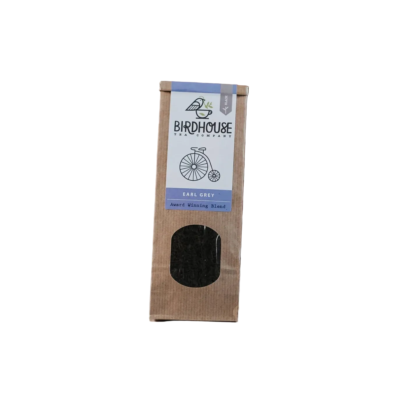 Tea package with loose tea leaves on a surface against a brick wall background
