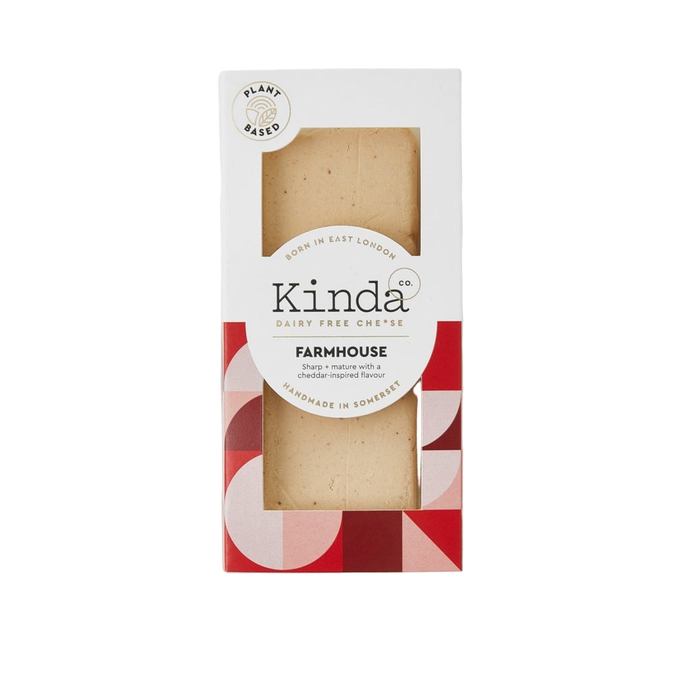 Close-up of Kinda Cheese Co. Vegan Farmhouse Cheese Block on a white background 