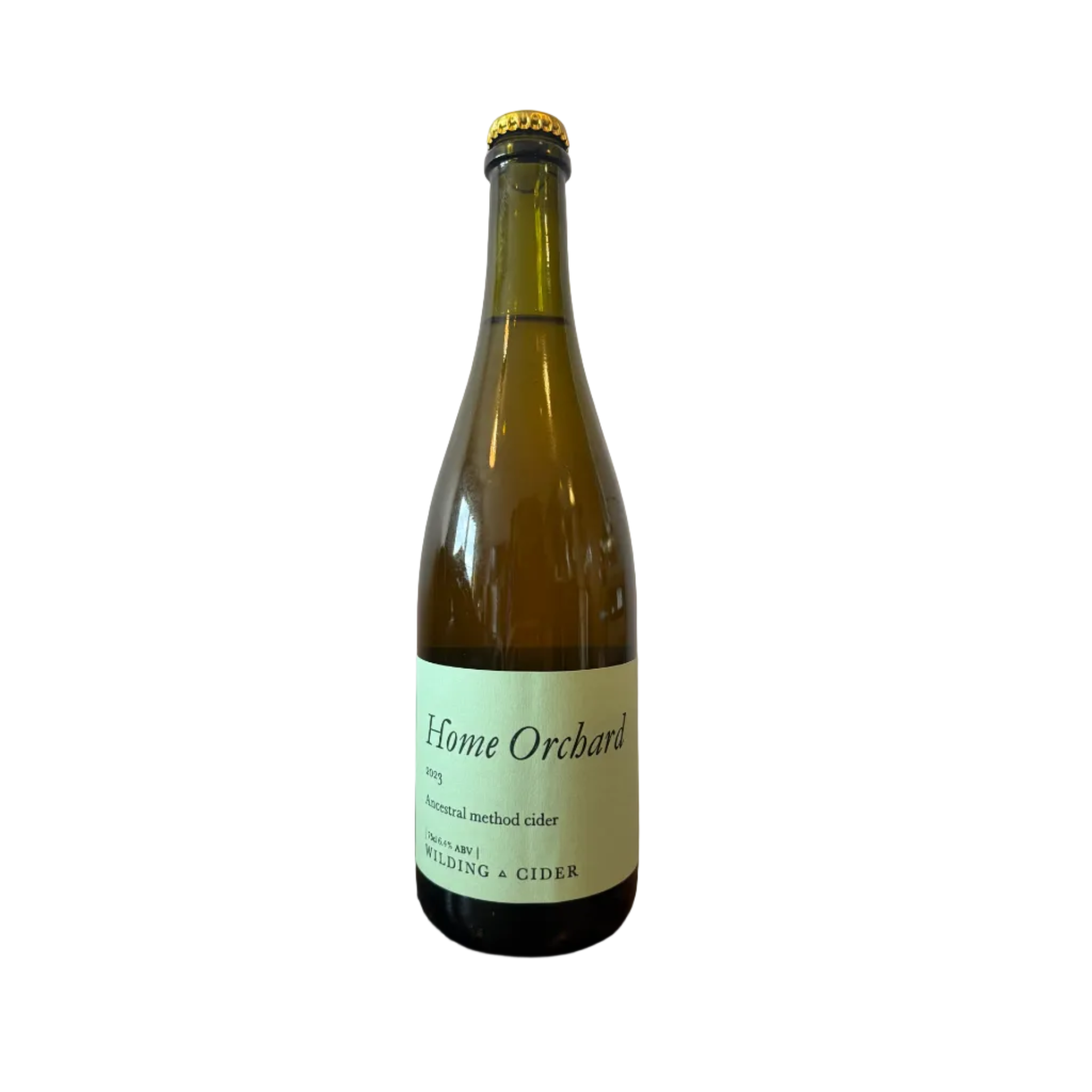 Bottle of 'Home Orchard' cider on a wooden surface with a plain background