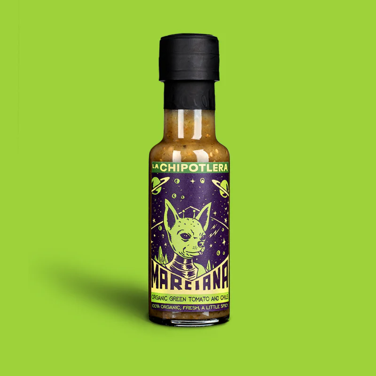 Hot sauce bottle with a black cap on a green background