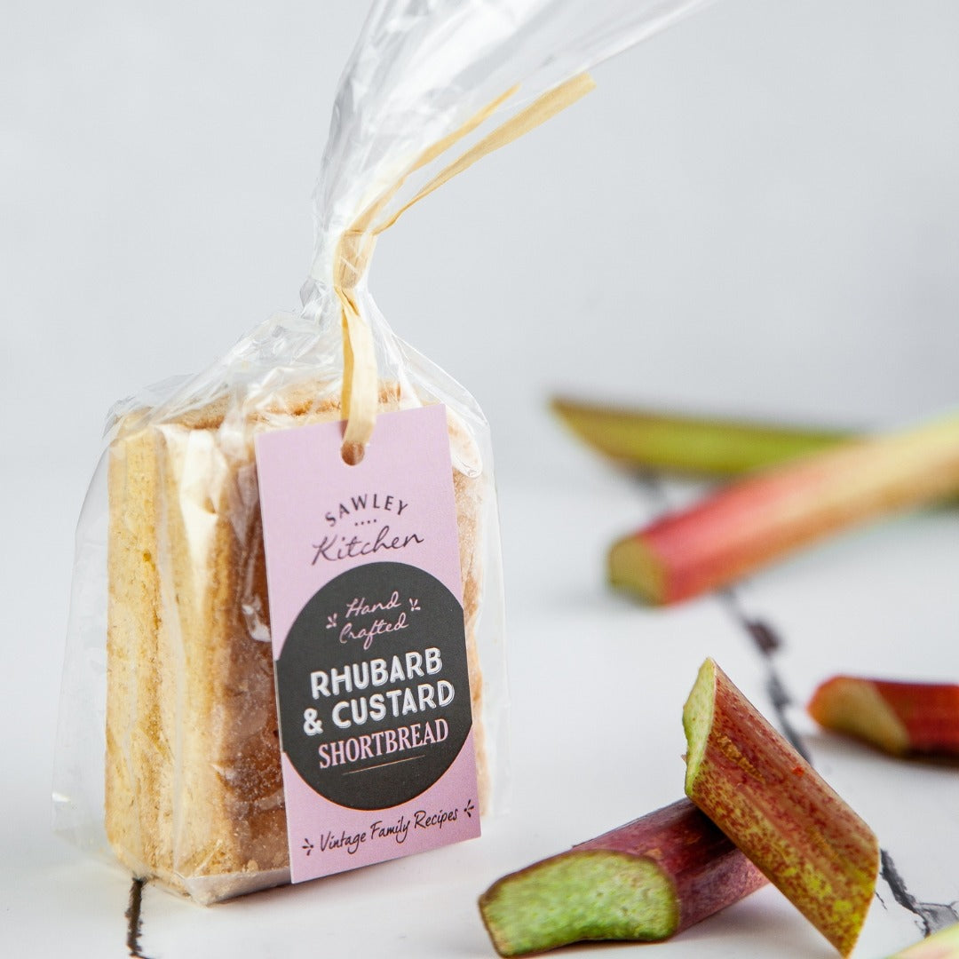 Packaged rhubarb and custard shortbread with a tag on a white background