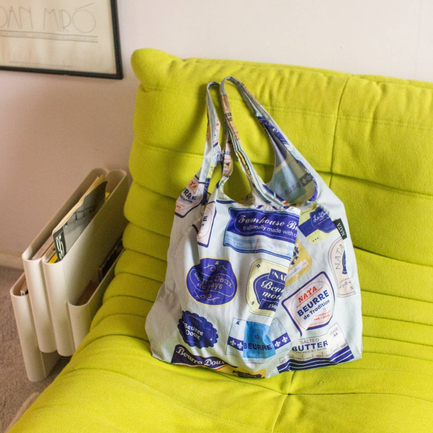 Blue Reuseable bag on placed on a green sofa