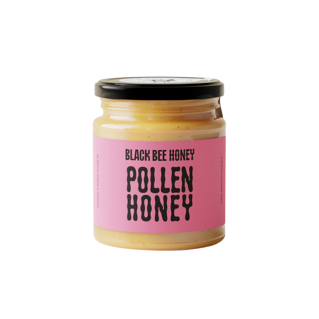 A jar of Black Bee Honey Pollen Honey with a bright pink label and a black lid, set against a plain white background.