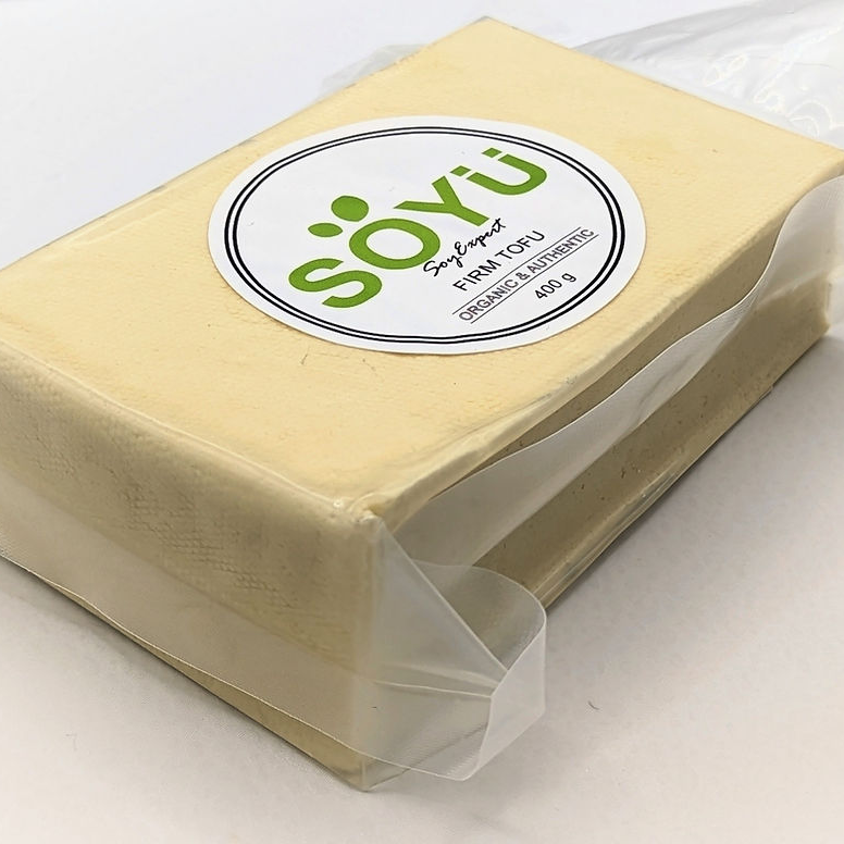 Block of tofu with a 'soyu' label on a white background