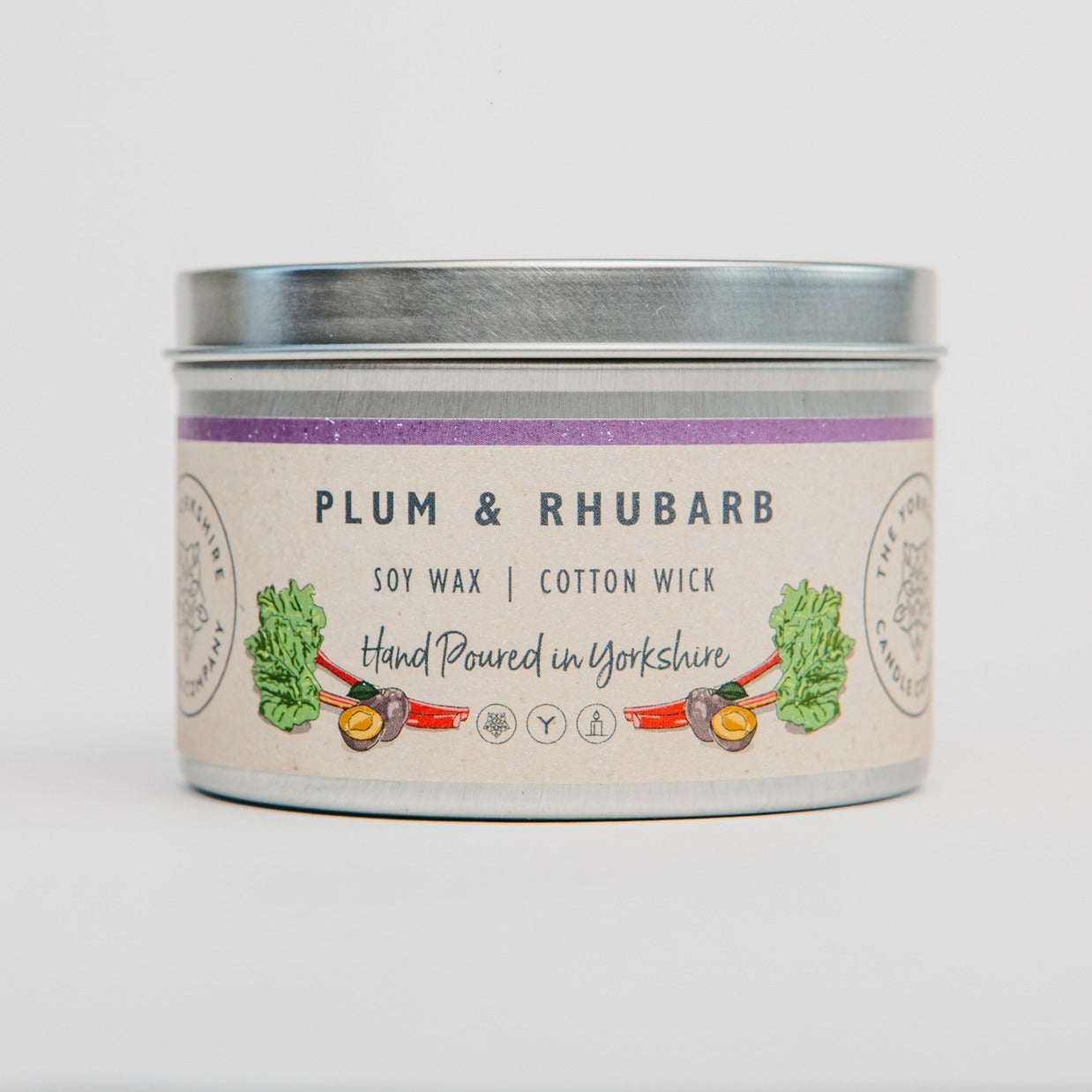 Candle tin labeled 'Plum & Rhubarb' with a white background