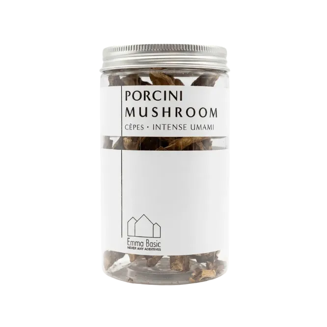 A clear plastic jar of Emma Basic Porcini Mushroom (Cèpes Intense Umami) with a white label and silver metal lid, containing dried porcini mushrooms.